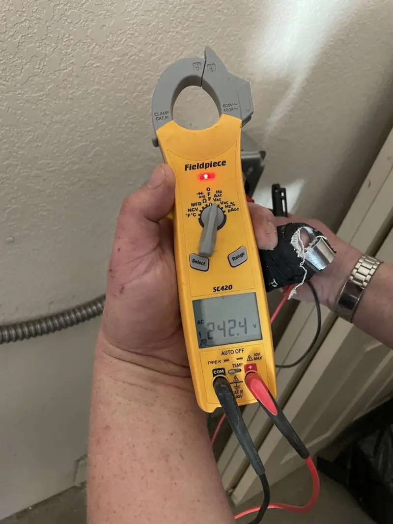 Voltage testing with clamp meter during Outlet Installation in Lexington
